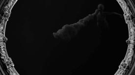 Cloudy substance floating against a black background