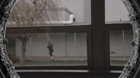 Person running in a school courtyard