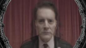 Image of Dale Cooper and Mr. C on red drapes
