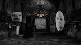 Theatre with a screen, golden machine and floating heads