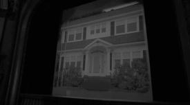 Movie screen with an image a white house