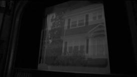 Movie screen with an image a white house