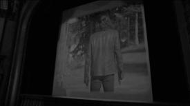Person on a move theatre screen with his back turned